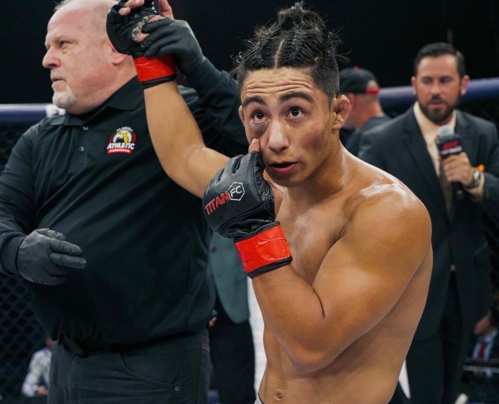 Ryan Ocasio celebrating a Titan FC win with his hand raised