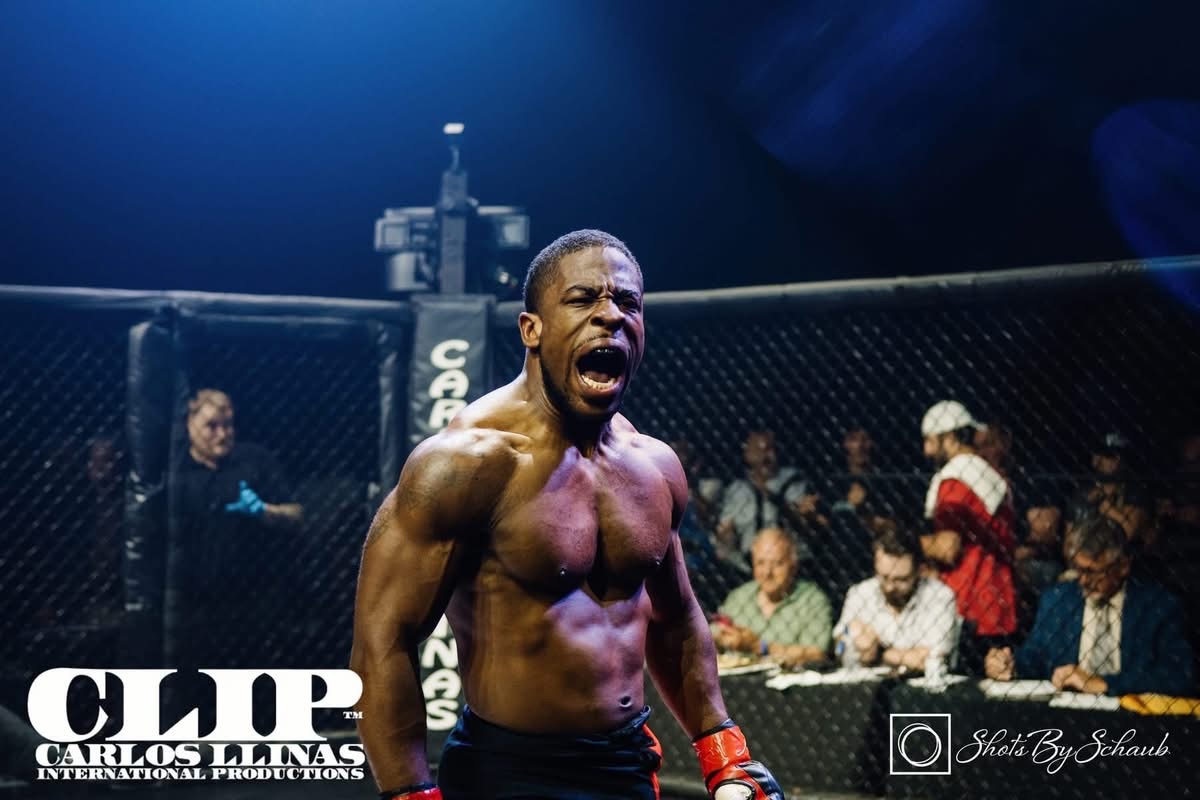 Devin Thomas roaring in celebration inside the cage