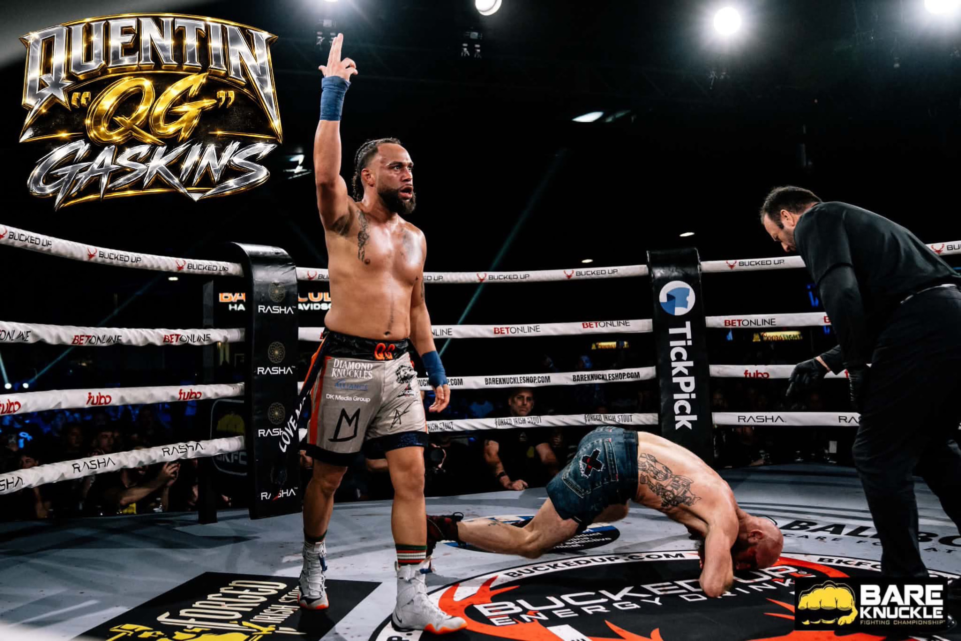 Quentin "QG" Gaskins raising his hand in victory as his opponent falls in the BKFC ring