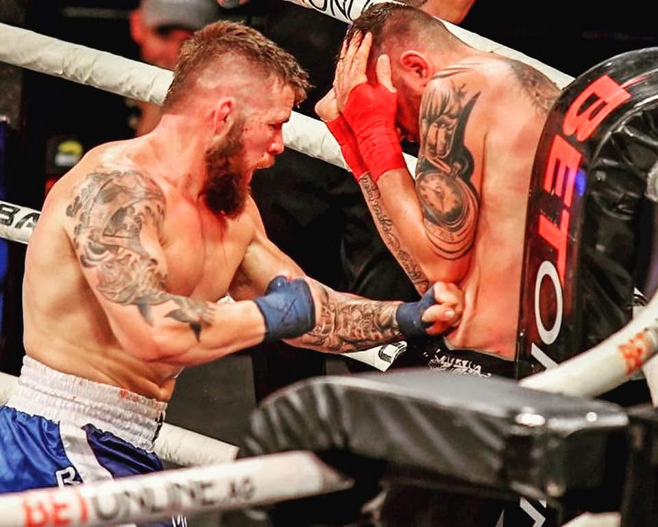Dave "Redneck" Mundell pressing forward with body shots during a BKFC fight