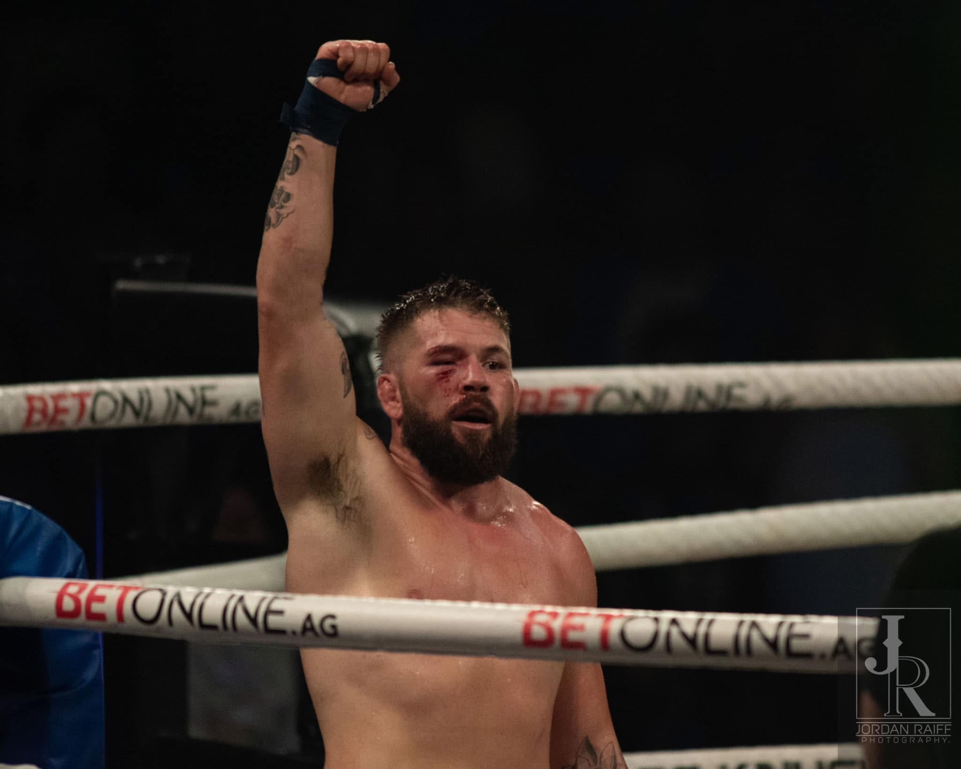 Dave "Redneck" Mundell raising his fist in victory inside the ring