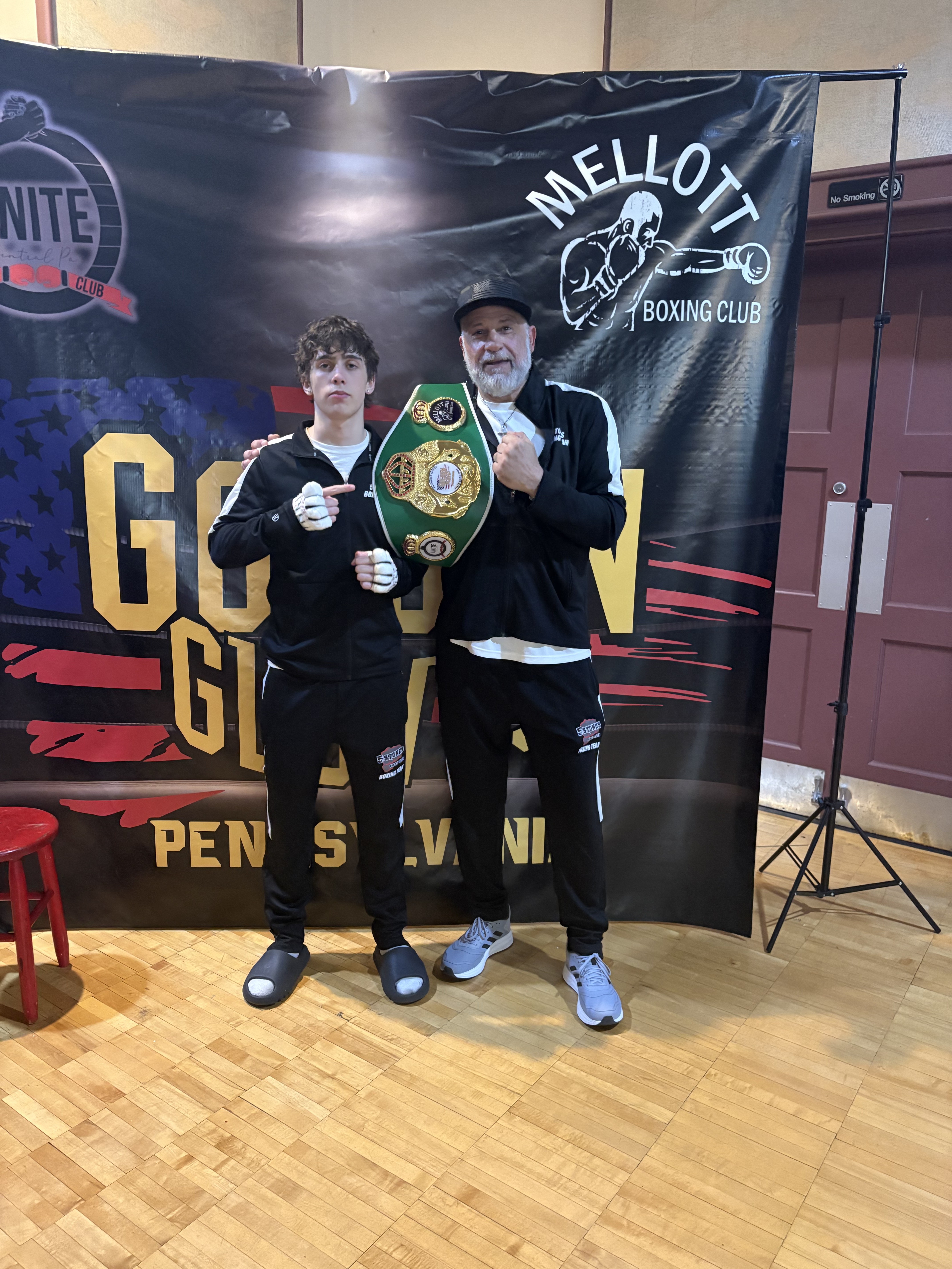Andrew Waybright's coach holding up his championship belt