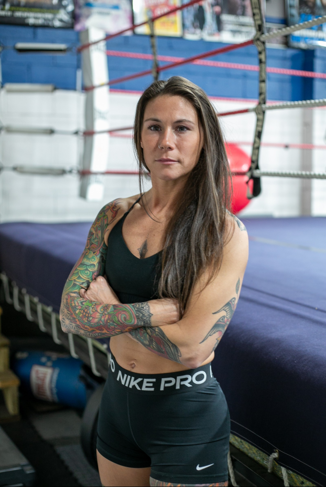 Brooke Evans with arms crossed beside the boxing ring
