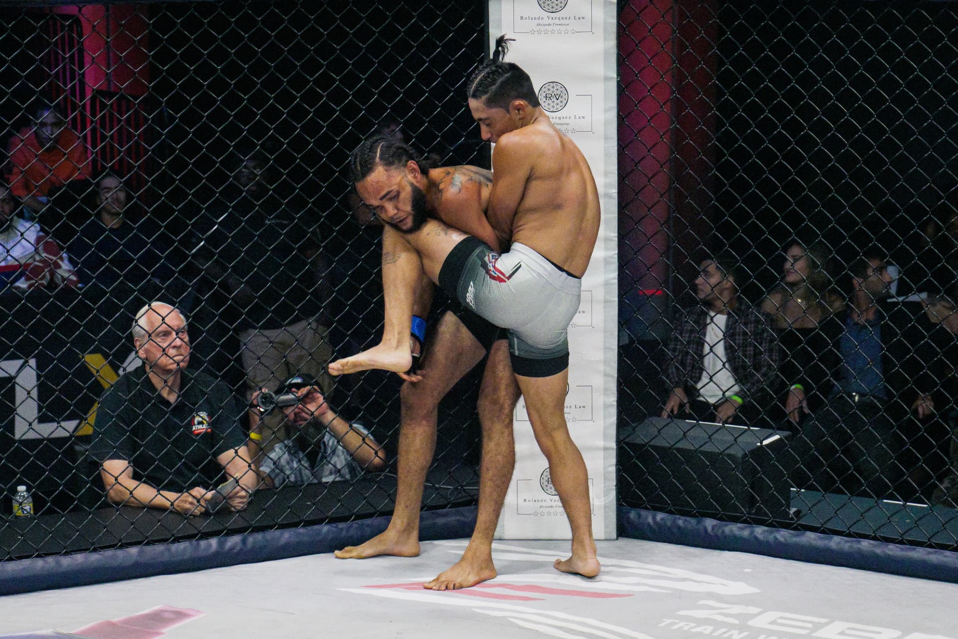 Ryan Ocasio locking up a clinch against the cage