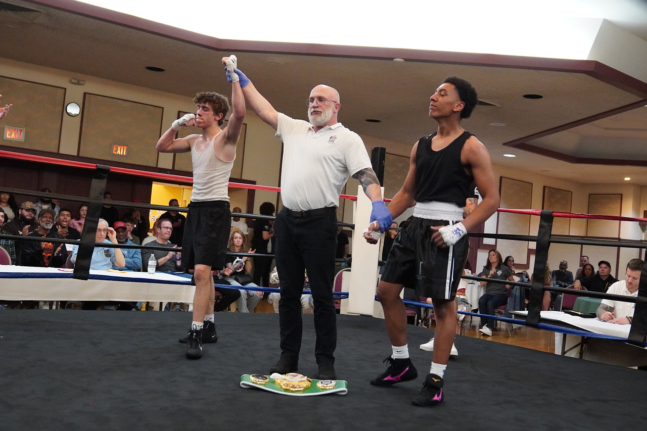 Andrew Waybright having his hand raised by the referee after a win