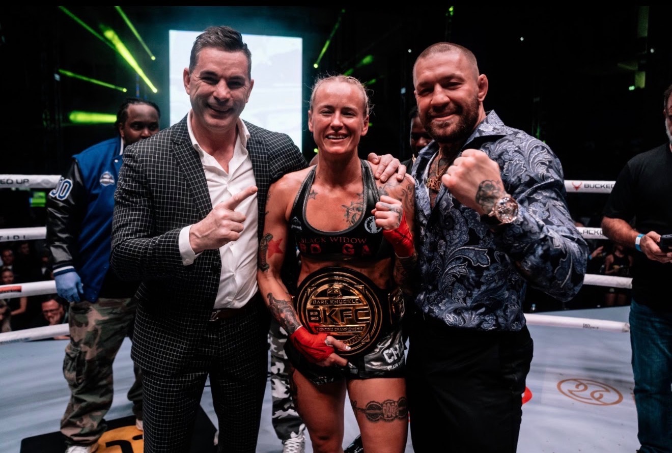 Jessica Borga in the ring with the BKFC championship belt after her title win