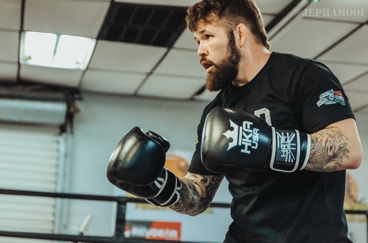 Dave "Redneck" Mundell working the heavy mitts in black HKFA USA gloves at the gym