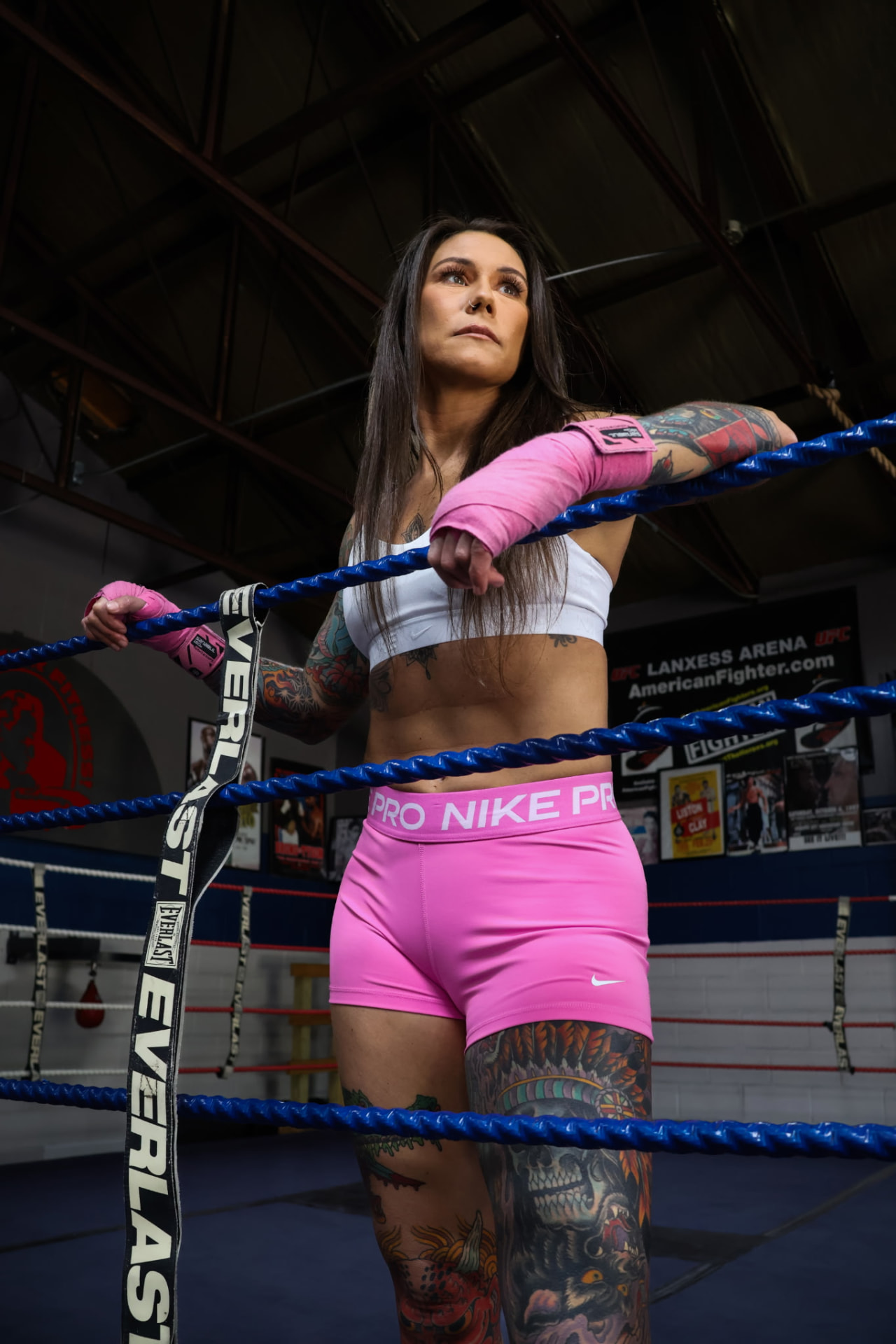 Brooke Evans leaning on the ring ropes in the gym