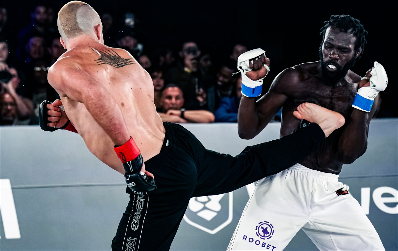Tommy Aaron delivering a head kick in competition