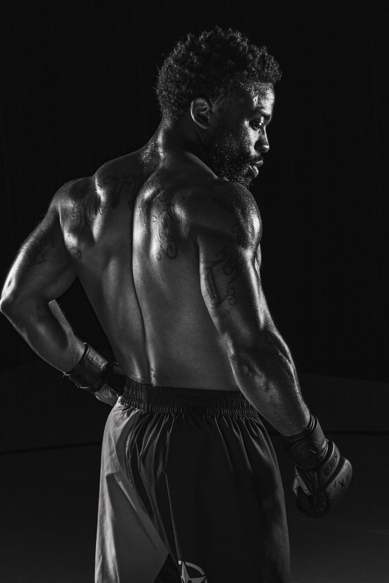 Devin Thomas photographed from behind showing his tattoos
