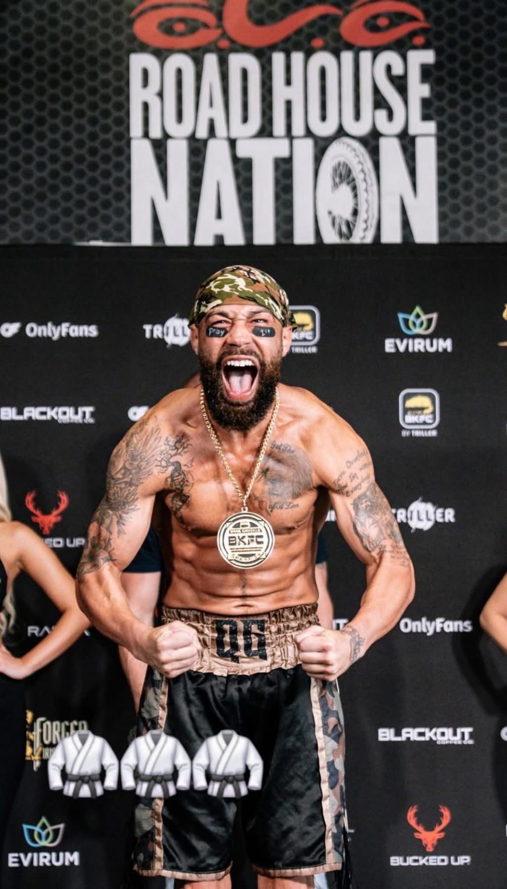 Quentin "QG" Gaskins roaring at the BKFC weigh-in with his championship medal