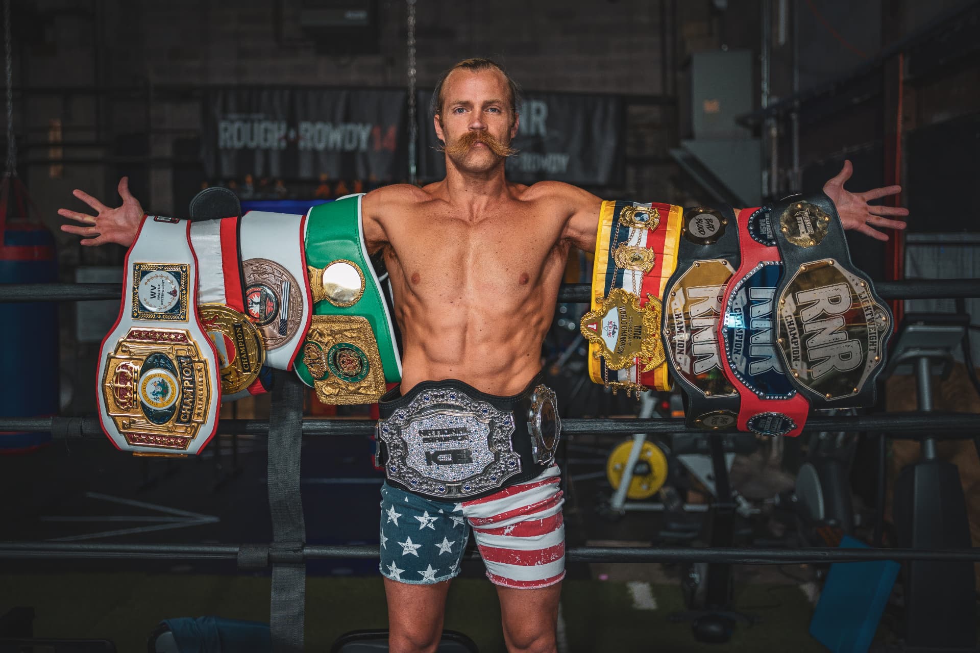 Brendan Kelly displaying his full championship belt collection