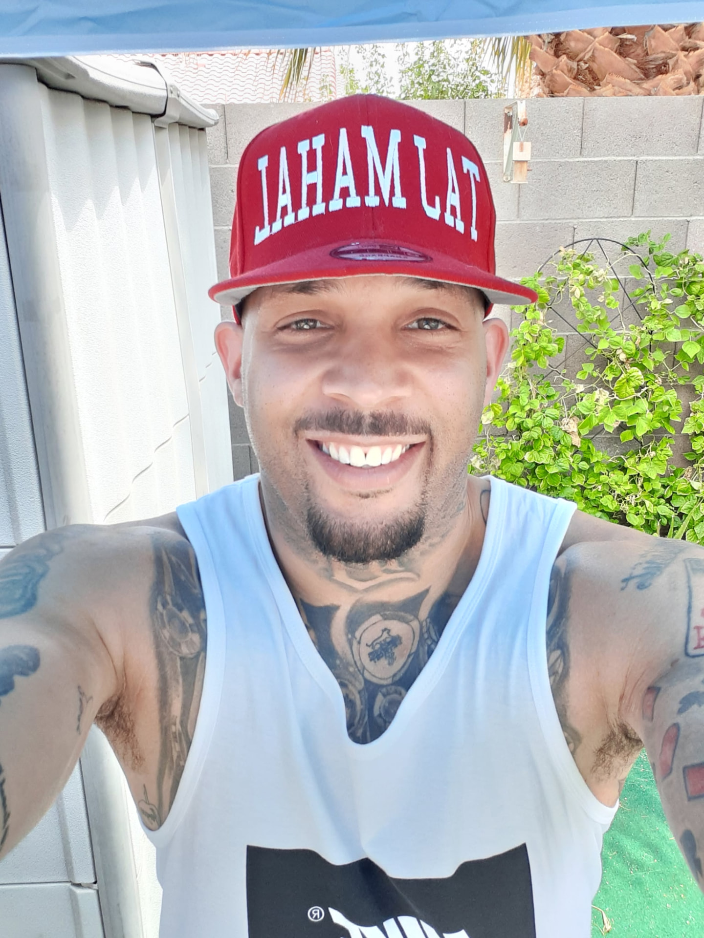 Terryl Johnson smiling in a red cap outdoors